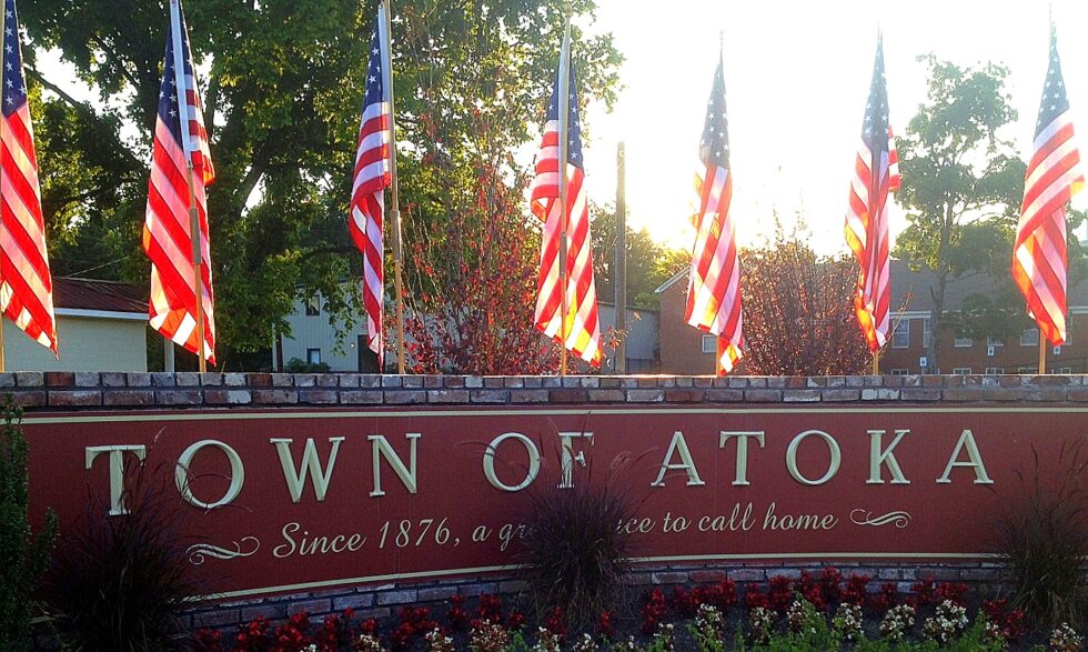 Town of Atoka welcome sign with American flags in Tipton County, Tennessee